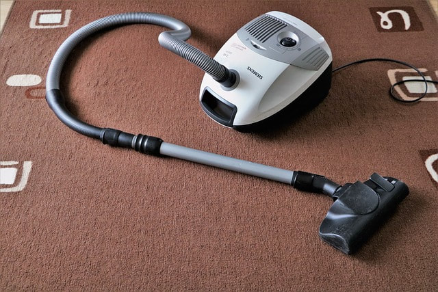 a vaccum cleaner on a rug at a customers home